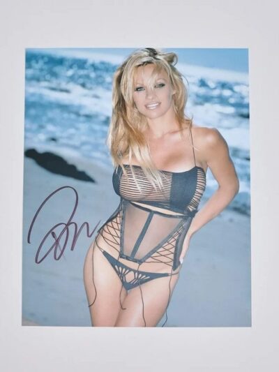 Woman in black swimsuit on beach.