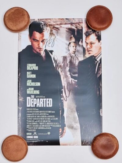 Movie poster with autographs and round objects.