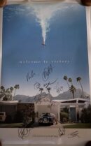 Movie poster with autographs and palm trees.