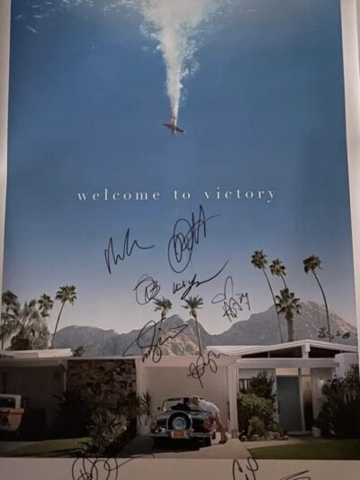 Movie poster with autographs and palm trees.