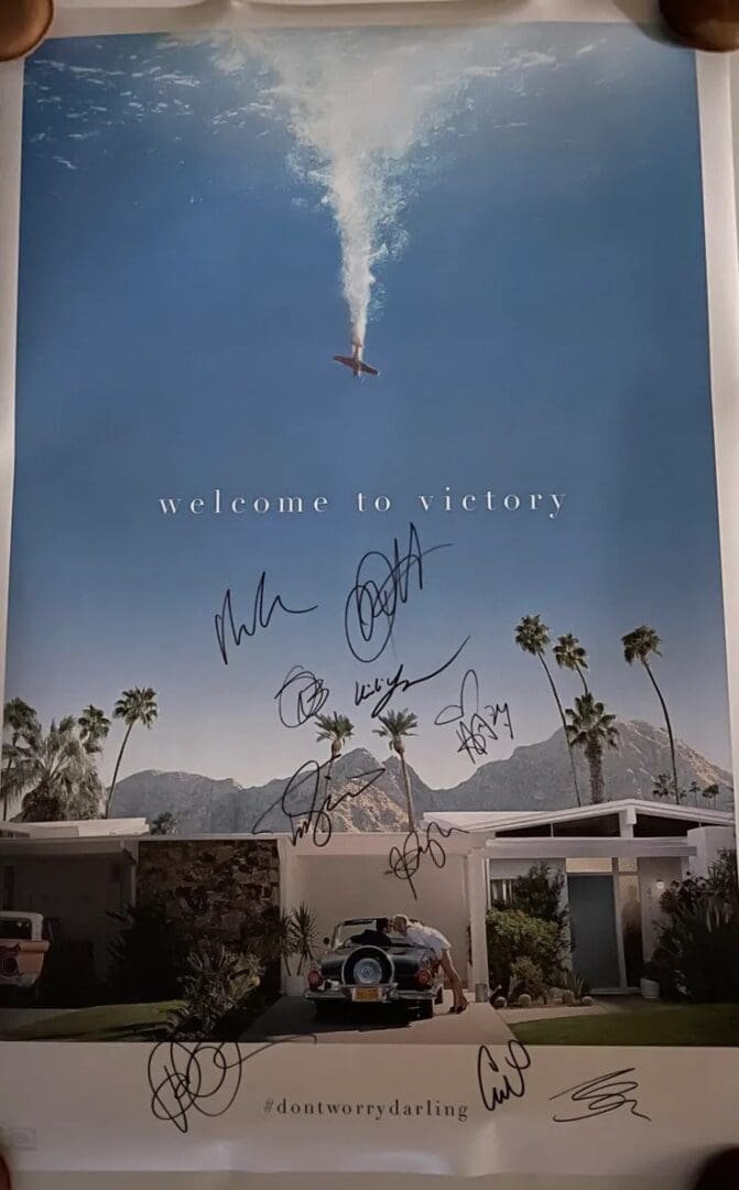 Movie poster with autographs and palm trees.