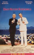 Two men in suits raising glasses on beach