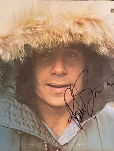 Autographed album cover with person in fur-lined hood
