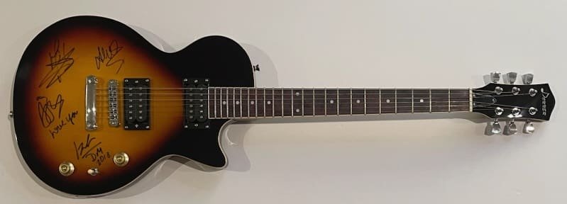Sunburst electric guitar with autographs on body.