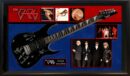 Framed guitar and band memorabilia display.