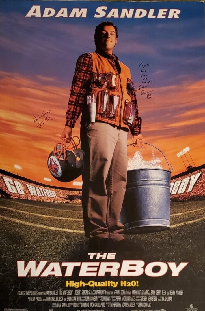 Man holding helmet and bucket on football field