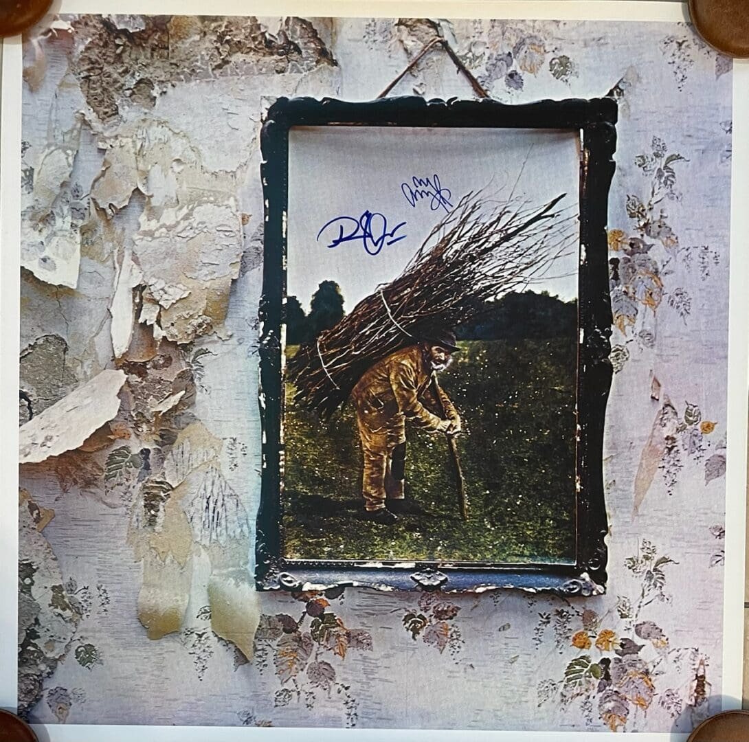 Framed picture of man carrying sticks.