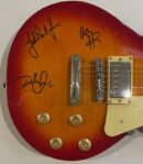 Close-up of signed electric guitar body.